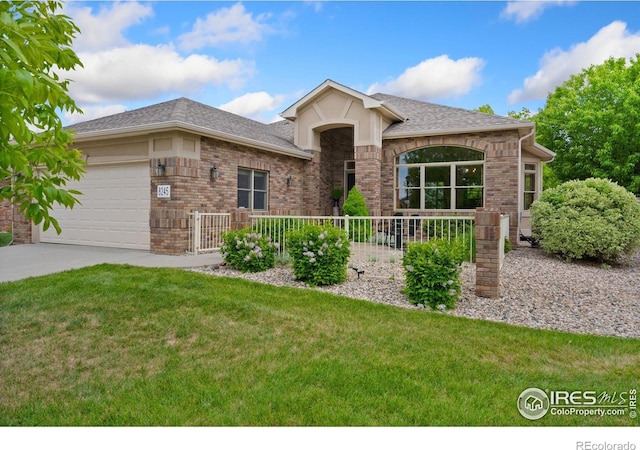 8245 Hidden Cove Ct, Windsor, CO 80528 - view of front of home featuring an attached garage, a front yard, concrete driveway, and roof with shingles