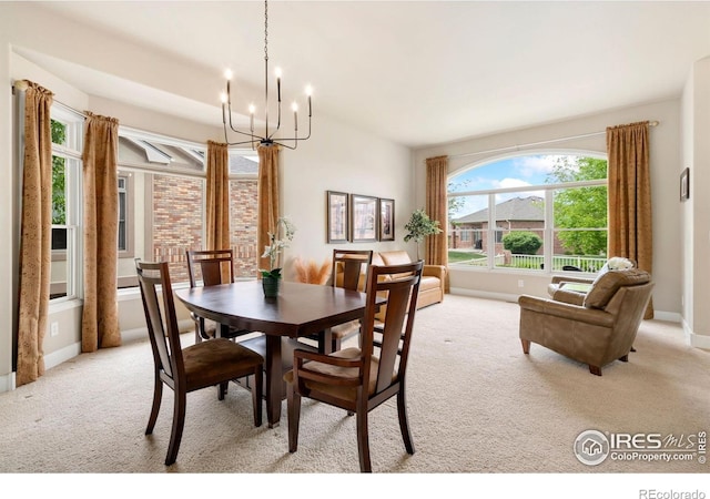 8245 Hidden Cove Ct, Windsor, CO 80528 - dining space with a chandelier, light carpet, and baseboards