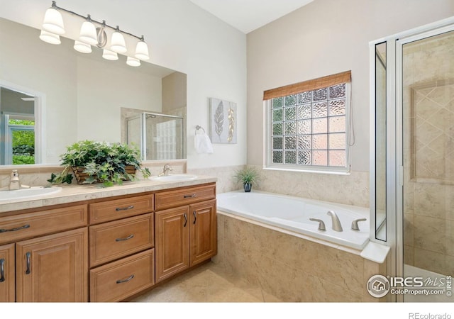8245 Hidden Cove Ct, Windsor, CO 80528 - full bathroom with a shower stall, a garden tub, double vanity, and tile patterned flooring