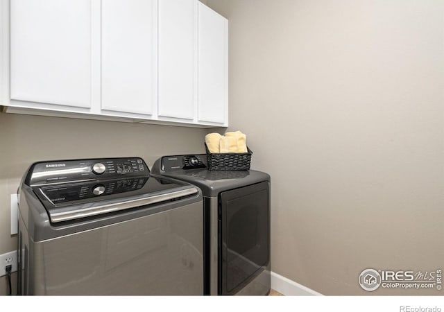 8245 Hidden Cove Ct, Windsor, CO 80528 - laundry area with cabinet space, independent washer and dryer, and baseboards