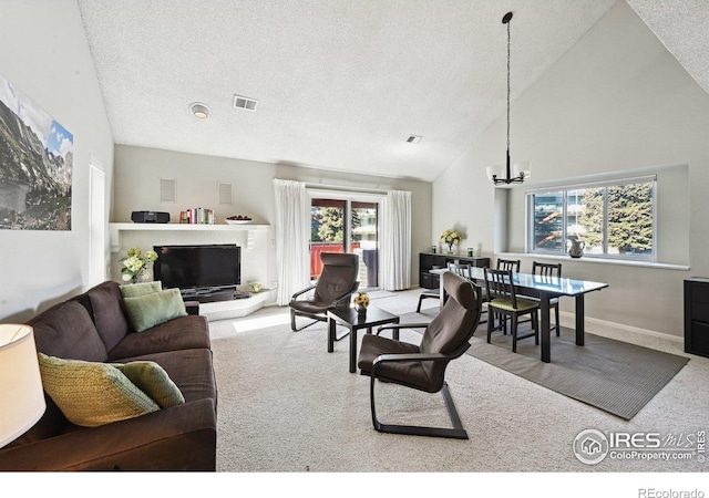 4475 Laguna Pl Unit 201, Boulder, CO 80303 - carpeted living room featuring high vaulted ceiling, a chandelier, plenty of natural light, a textured ceiling, and baseboards