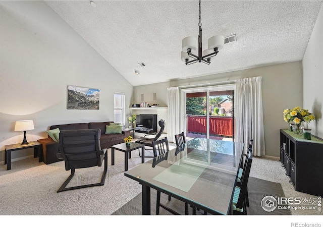 4475 Laguna Pl Unit 201, Boulder, CO 80303 - carpeted dining space with a chandelier, a textured ceiling, and high vaulted ceiling