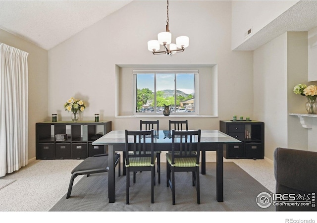 4475 Laguna Pl Unit 201, Boulder, CO 80303 - carpeted dining space featuring a chandelier and high vaulted ceiling