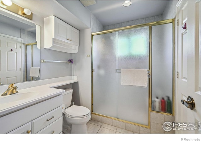4475 Laguna Pl Unit 201, Boulder, CO 80303 - bathroom featuring tile patterned floors, a stall shower, vanity, and toilet