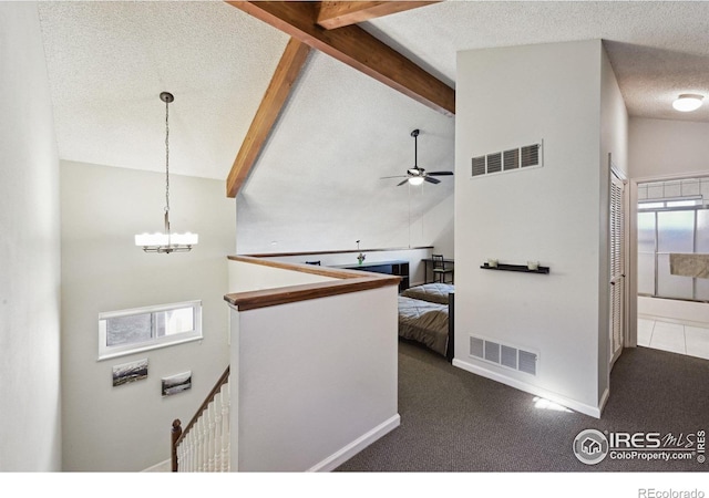 4475 Laguna Pl Unit 201, Boulder, CO 80303 - hall with a textured ceiling, an upstairs landing, beamed ceiling, a chandelier, and dark colored carpet