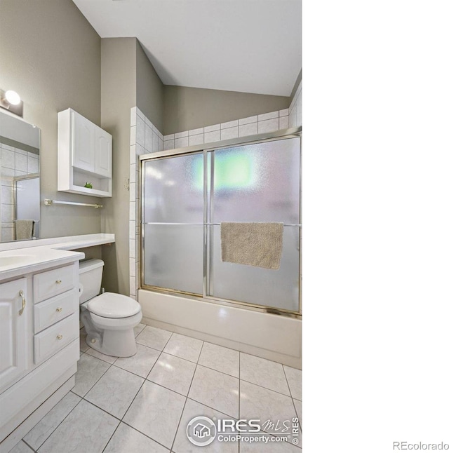 4475 Laguna Pl Unit 201, Boulder, CO 80303 - full bathroom with lofted ceiling, toilet, vanity, tile patterned flooring, and shower / bath combination with glass door