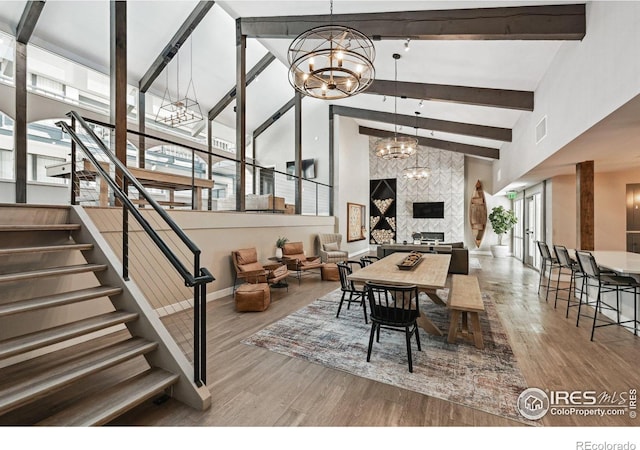 4475 Laguna Pl Unit 201, Boulder, CO 80303 - dining area with a chandelier, high vaulted ceiling, wood finished floors, stairs, and beamed ceiling