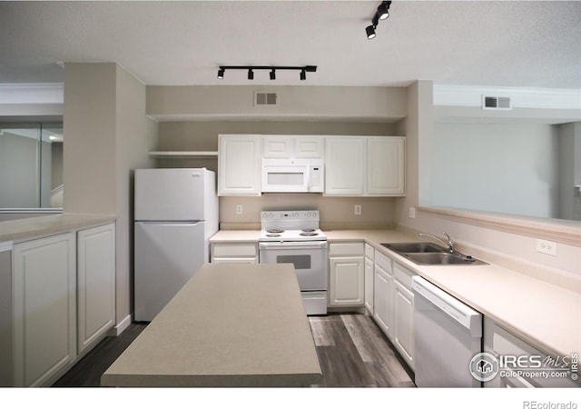 2162 Concord Ln, Superior, CO 80027 - kitchen with white appliances, a sink, dark wood-type flooring, white cabinets, and rail lighting