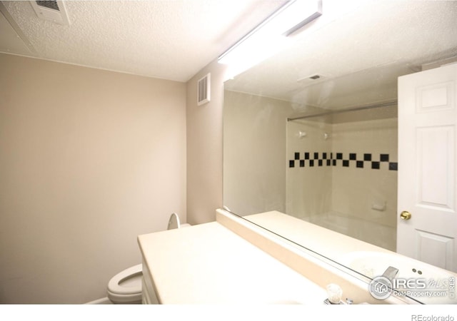 2162 Concord Ln, Superior, CO 80027 - bathroom featuring a shower, toilet, and a textured ceiling