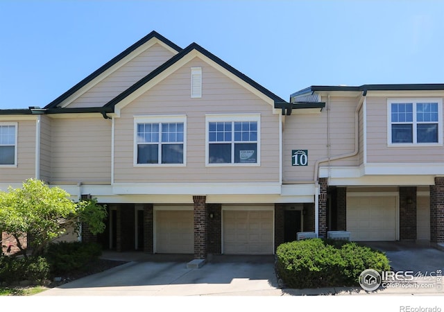 2162 Concord Ln, Superior, CO 80027 - view of front of home featuring an attached garage, brick siding, and driveway
