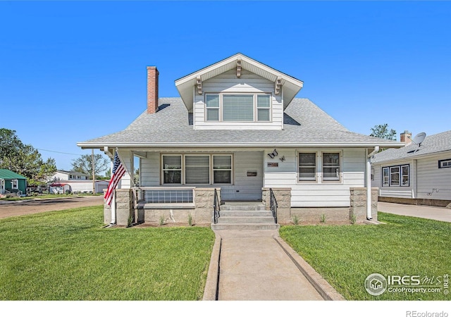501 Adams Ave, Akron, CO 80720 - bungalow with covered porch, a front yard, a chimney, and roof with shingles