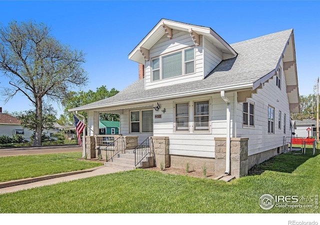 501 Adams Ave, Akron, CO 80720 - view of front of property with a front lawn, covered porch, and a shingled roof