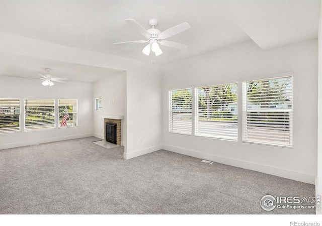 501 Adams Ave, Akron, CO 80720 - unfurnished living room featuring a ceiling fan, carpet flooring, baseboards, and a brick fireplace