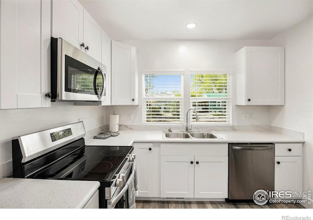 501 Adams Ave, Akron, CO 80720 - kitchen with stainless steel appliances, a sink, white cabinetry, light countertops, and recessed lighting