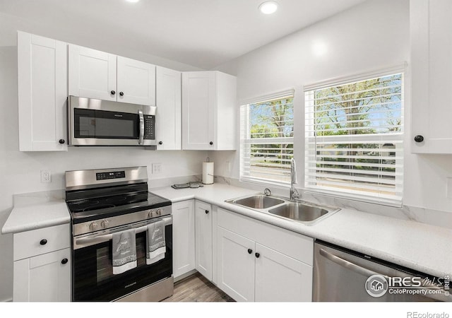 501 Adams Ave, Akron, CO 80720 - kitchen with appliances with stainless steel finishes, a sink, white cabinets, and recessed lighting