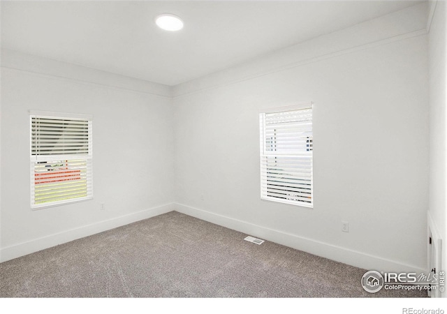 501 Adams Ave, Akron, CO 80720 - empty room with carpet floors, plenty of natural light, and baseboards