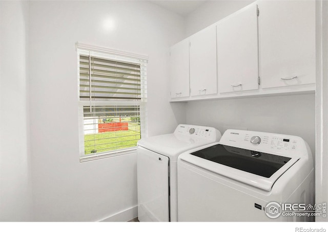 501 Adams Ave, Akron, CO 80720 - washroom with cabinet space and washing machine and clothes dryer