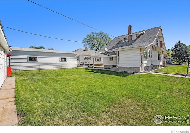 501 Adams Ave, Akron, CO 80720 - rear view of property with a chimney and a shingled roof
