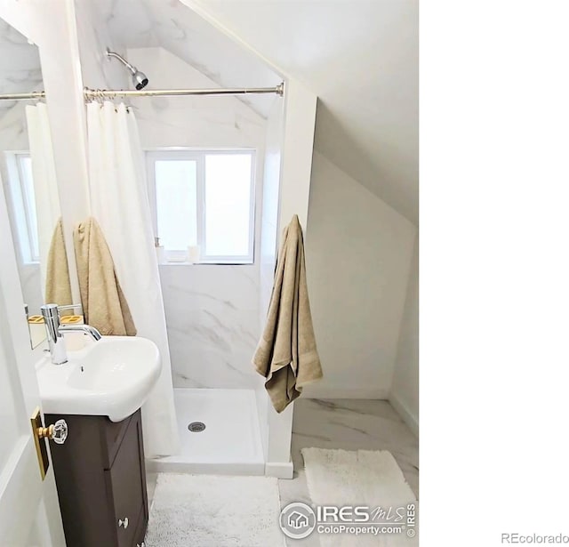 501 Adams Ave, Akron, CO 80720 - full bath with marble look tiles, a stall shower, vanity, and vaulted ceiling