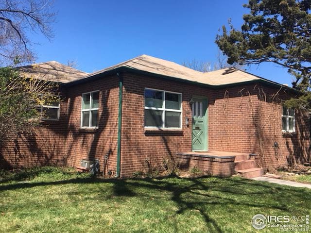 3201 Broadway St, Boulder, CO 80304 - view of home's exterior featuring brick siding and a lawn