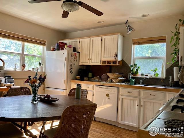 3201 Broadway St, Boulder, CO 80304 - kitchen with white appliances, a ceiling fan, light wood-style flooring, and white cabinets