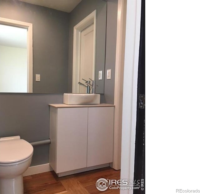 3201 Broadway St, Boulder, CO 80304 - bathroom with toilet, vanity, baseboards, and wood finished floors
