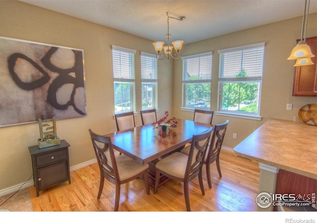 705 Rawlins Way, Lafayette, CO 80026 - dining room featuring a chandelier, light wood-style floors, and healthy amount of natural light