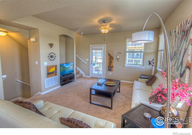 705 Rawlins Way, Lafayette, CO 80026 - carpeted living area with stairs, a ceiling fan, and baseboards