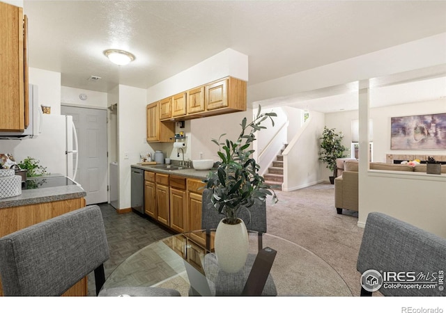 1215 Centaur Cir Unit A, Lafayette, CO 80026 - kitchen featuring a sink, open floor plan, dishwasher, and baseboards