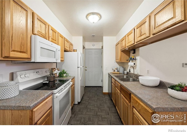 1215 Centaur Cir Unit A, Lafayette, CO 80026 - kitchen featuring white appliances, a sink, and dark countertops