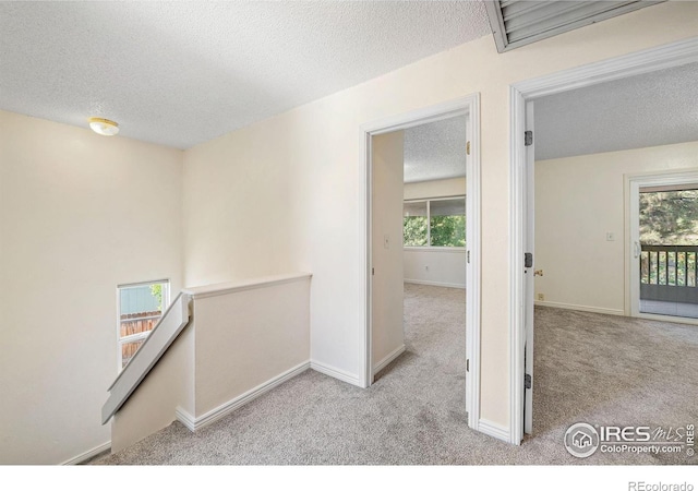1215 Centaur Cir Unit A, Lafayette, CO 80026 - hall with a textured ceiling, carpet, an upstairs landing, and baseboards