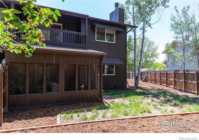 1215 Centaur Cir Unit A, Lafayette, CO 80026 - back of house featuring a chimney, a balcony, and a sunroom