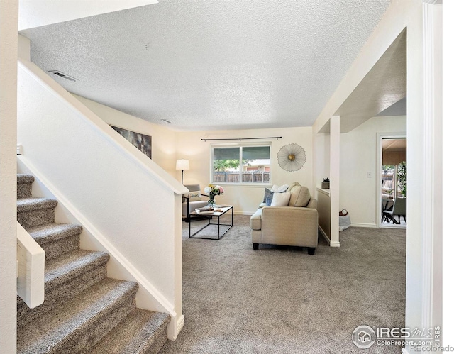 1215 Centaur Cir Unit A, Lafayette, CO 80026 - carpeted living area with a textured ceiling, stairs, and baseboards