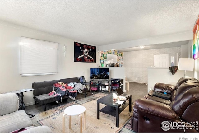 810 W Laurel St, Fort Collins, CO 80521 - living area featuring a textured ceiling and brick wall