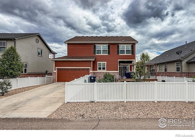2190 Winding Dr, Longmont, CO 80504 - view of front of house featuring concrete driveway and a fenced front yard