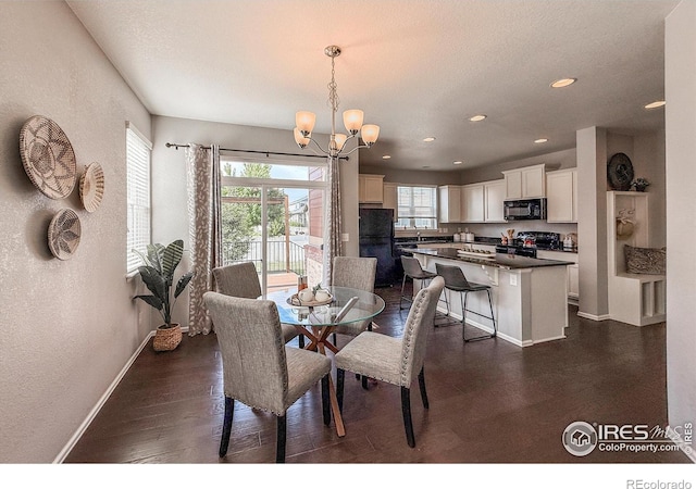 2190 Winding Dr, Longmont, CO 80504 - dining area featuring a chandelier, recessed lighting, dark wood-type flooring, and a textured wall