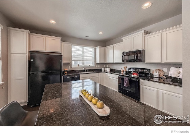 2190 Winding Dr, Longmont, CO 80504 - kitchen featuring black appliances, white cabinets, recessed lighting, dark stone countertops, and a textured ceiling