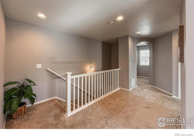 2190 Winding Dr, Longmont, CO 80504 - corridor with carpet, arched walkways, recessed lighting, and an upstairs landing