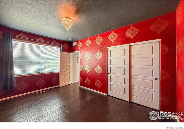 2190 Winding Dr, Longmont, CO 80504 - unfurnished bedroom with wood finished floors and a textured ceiling