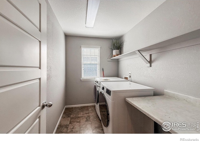 2190 Winding Dr, Longmont, CO 80504 - laundry area with independent washer and dryer, a textured wall, stone finish floors, and a textured ceiling