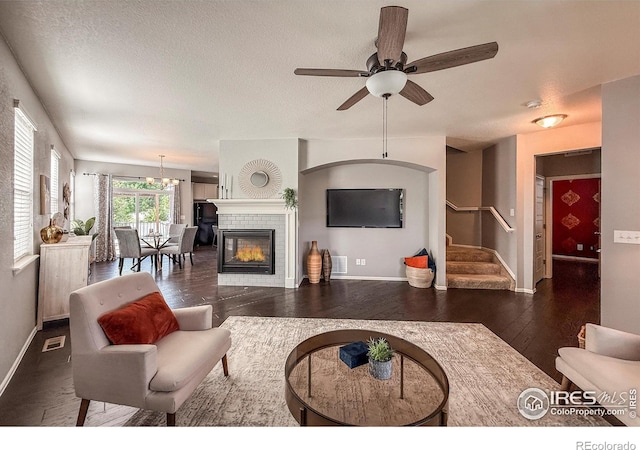 2190 Winding Dr, Longmont, CO 80504 - living area featuring wood finished floors, stairway, ceiling fan, a tile fireplace, and a textured ceiling