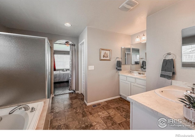 2190 Winding Dr, Longmont, CO 80504 - bathroom with vanity, a garden tub, ensuite bathroom, and stone finish floors