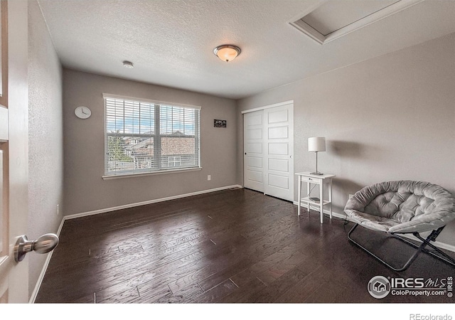 2190 Winding Dr, Longmont, CO 80504 - unfurnished room featuring dark wood-type flooring, attic access, and a textured ceiling