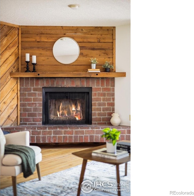 2725 Juniper Ave Unit 78, Boulder, CO 80304 - living area with a brick fireplace, wood walls, and wood finished floors