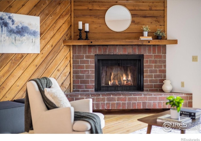 2725 Juniper Ave Unit 78, Boulder, CO 80304 - living room with wooden walls, a brick fireplace, and wood finished floors