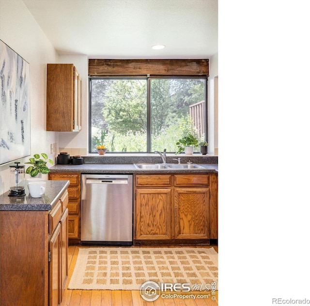2725 Juniper Ave Unit 78, Boulder, CO 80304 - kitchen with dishwasher, a sink, dark countertops, and brown cabinets