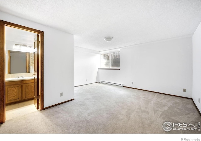 2725 Juniper Ave Unit 78, Boulder, CO 80304 - empty room featuring a baseboard radiator, light colored carpet, a sink, and baseboards