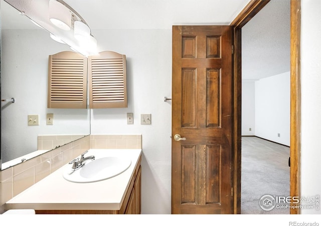 2725 Juniper Ave Unit 78, Boulder, CO 80304 - bathroom with vanity and decorative backsplash