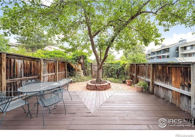 2725 Juniper Ave Unit 78, Boulder, CO 80304 - wooden deck featuring a fenced backyard and outdoor dining area