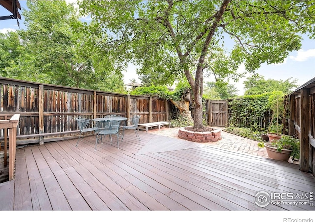 2725 Juniper Ave Unit 78, Boulder, CO 80304 - wooden terrace featuring a fenced backyard and outdoor dining space